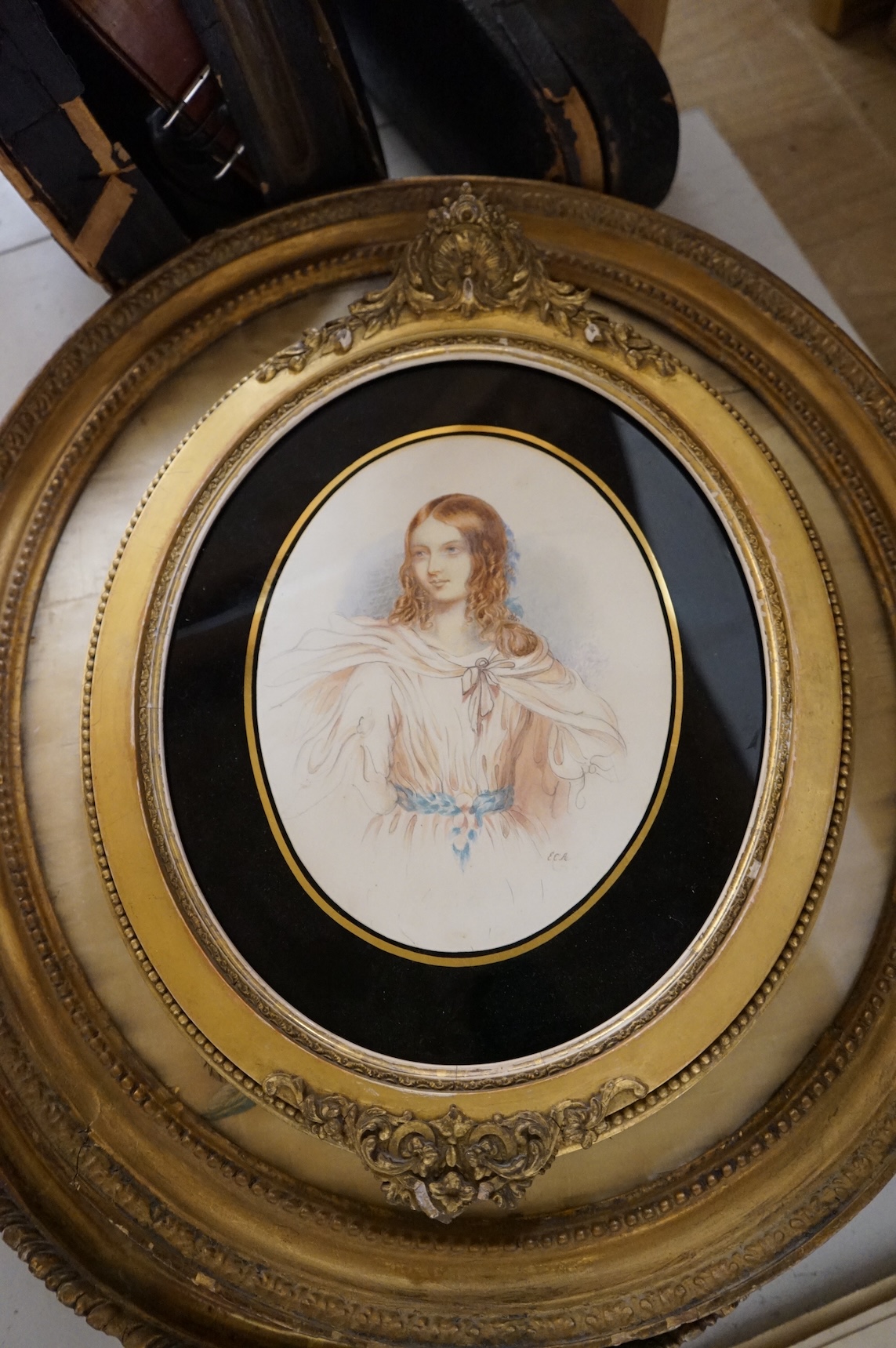Two 18th century oval silkwork panels, one depicting flowers, monogrammed AM and dated 1787, together with a 19th century watercolour portrait of a lady, largest 42cm high